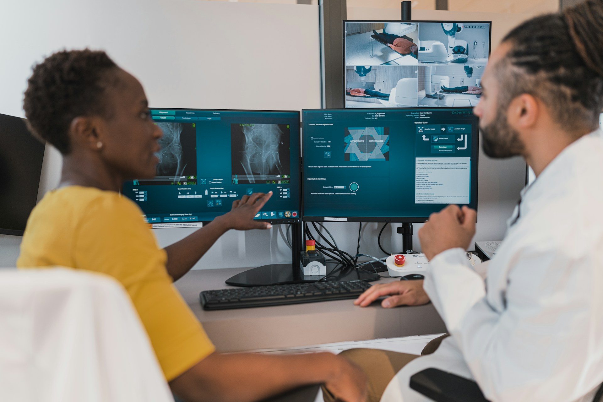 Clinical team reviewing device workflows across multiple screens